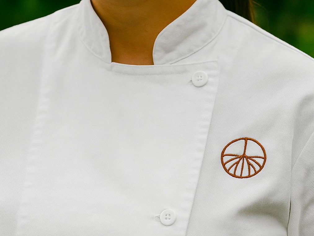 AMAU emblem embroidered on a white chef jacket