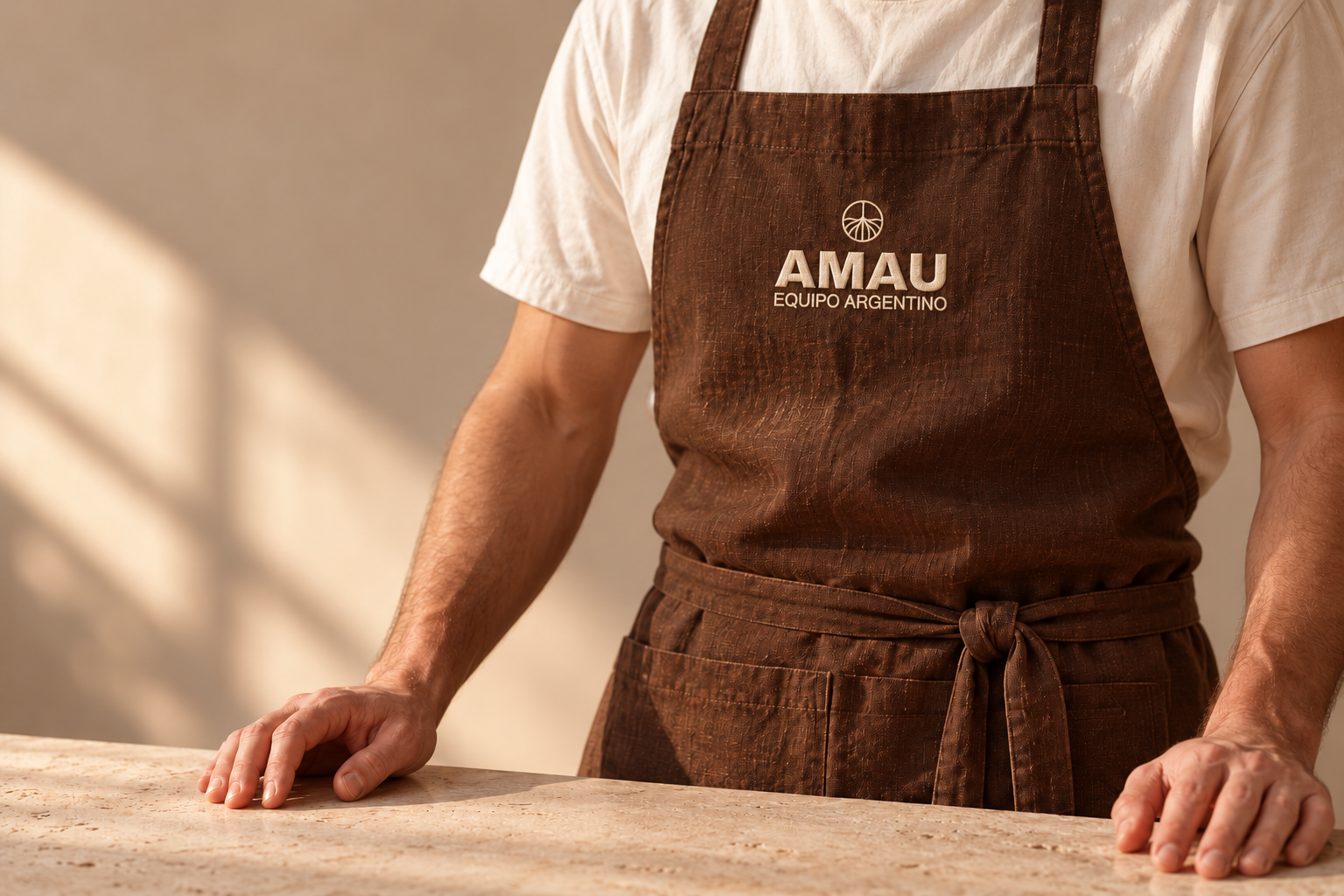 Conceptual cocoa AMAU apron with cream branding